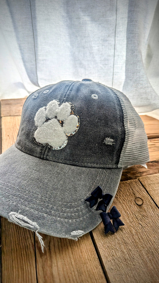 Set: Grey distressed mesh back pawprint hat and navy bow stud earrings